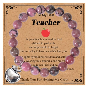 Detail of pink zebra stone beaded bracelet with apple charm on teacher gift card