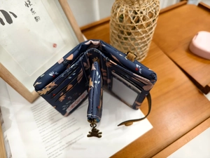 Detailed internal view of tri-fold daisy wallet with card slots and bear zipper puller