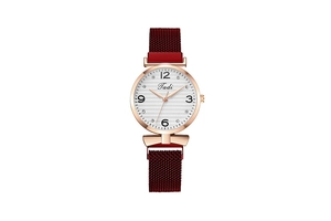 Detail of rose gold ladies watch featuring a burgundy mesh magnetic strap and Tadi dial