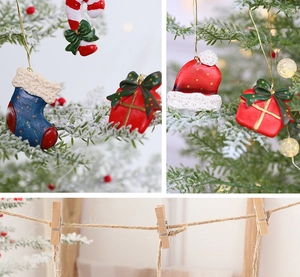 Detail view of assorted resin Christmas tree ornaments with red hats and gold strings