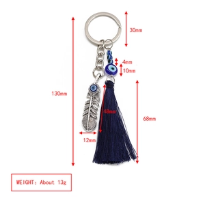 Detail showing dimensions of Evil Eye tassel keychain with feathers and blue glass beads