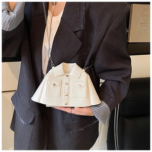 Detail of creative shirt-shaped white leather bag with metal buttons and chain strap