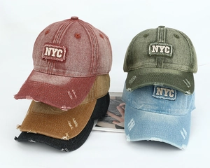 Detail of NYC embroidered patches and distressed cotton texture on vintage baseball caps
