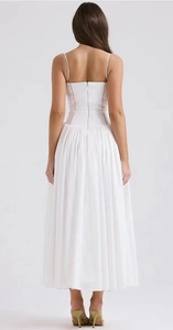 Rear view of white thin strap pleated maxi dress featuring back zipper and slim waist cut