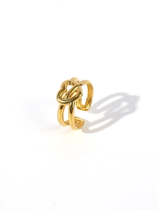 Detail of 18k gold plated open ring with an elegant heart knot design on white background