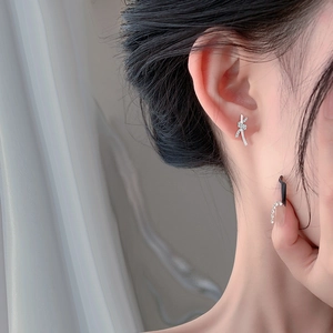 Elegant S999 sterling silver knot earrings with sparkling cubic zirconia on model