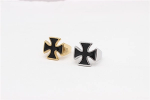 Detail of silver and gold stainless steel rings featuring black enamel Maltese crosses