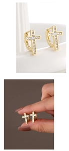 Macro detail of gold cross huggie earrings with S925 mark and clear cubic zirconia stones