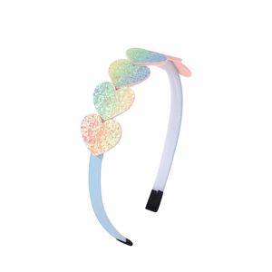Close-up of heart-shaped sequins with iridescent rainbow finish on blue fabric headband