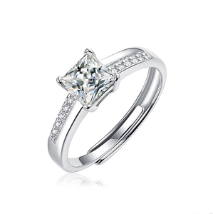 Close-up of square moissanite ring with polished silver finish and sparkling accents