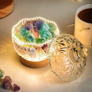 Detailed view of diamond pattern glass aroma jar with purple crystals and wooden base