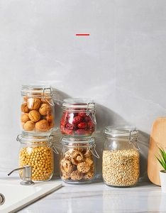 Five-piece glass storage jar set with airtight metal clamps for kitchen food organization