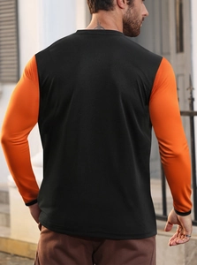 Rear view of men's athletic long sleeve shirt with black body and orange contrast sleeves