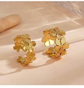 Macro detail of gold flower ring featuring textured petals and adjustable open design