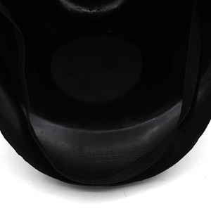 Detail of the black mask interior with adjustable elastic strap and safety warning text