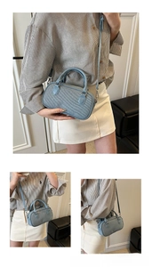 Detail of light blue denim texture Boston bag with silver hardware and styling view