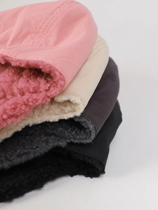 Dettaglio della fodera in lana di agnello e dell'esterno in nylon liscio dei berretti invernali