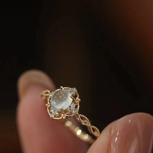 Macro detail of a vintage gold ring with cat-eye opal and floral hollow setting