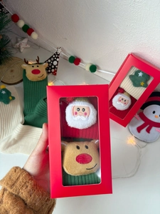 Festive Christmas gift box featuring knitted socks with 3D plush holiday decorations
