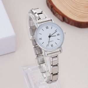 Detail shot of a silver rhinestone watch featuring a white quartz dial and roman numerals