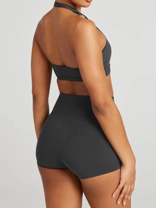 Rear view of black halter neck sports top and high waisted tight shorts yoga set