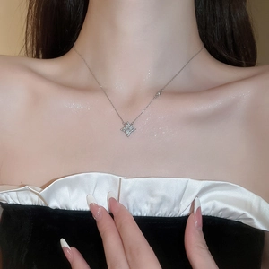 Close-up of sparkling silver star pendant necklace worn on neck highlighting elegant details