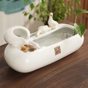 White ceramic flowing water fountain with cute geese figurines for office desk decor