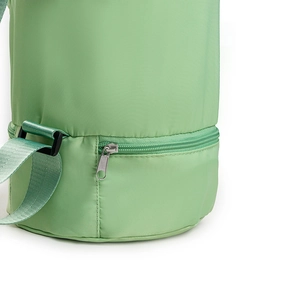 Close-up of light green yoga mat bag featuring a waterproof bottom zipper wet pocket