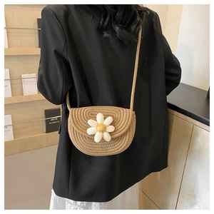 Detail of khaki cotton woven shoulder bag featuring a smiling daisy floral embroidery