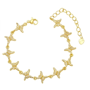 Gold butterfly link bracelet featuring sparkling white zircon accents and a heart charm