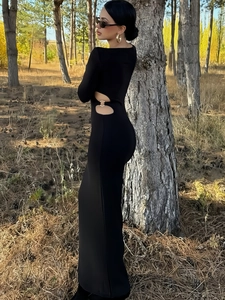 Elegant black long-sleeve maxi dress with waist cut-outs and metal ring accents