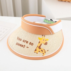 Detail of children straw sun hat featuring yellow giraffe print and orange fabric piping