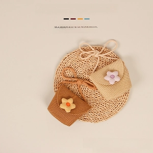 Close-up of handmade straw crossbody bags with fabric flowers for little girls