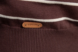 Detail of men's brown striped sweater featuring a premium knit texture and leather logo patch
