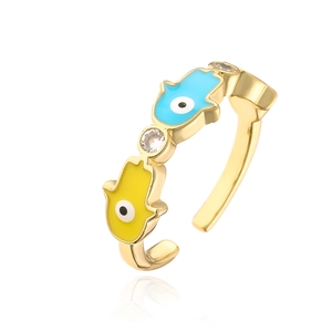 Macro shot of 18K gold plated Hamsa Hand ring with blue enamel and zircon detail