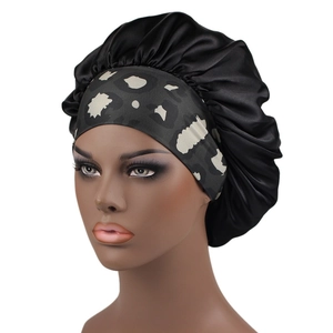 Detail of the satin sleep cap featuring a wide leopard print elastic headband for hair care