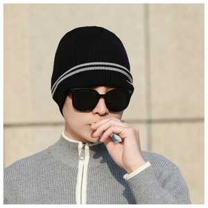 Close-up of a men's winter knit beanie with soft fleece lining and gray striped details