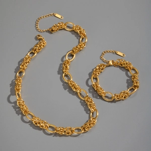 Detailed view of chunky 18K gold plated stainless steel knot necklace and bracelet set