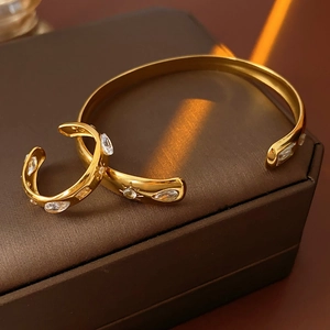 Detail of gold-plated bangle and ring set with teardrop marquise cubic zirconia