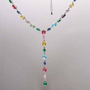Detail of Y-shaped silver necklace featuring colorful oval-cut crystals and adjustable chain