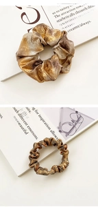 Detailed view of elastic golden brown silk scrunchie shown in flat and stretched states