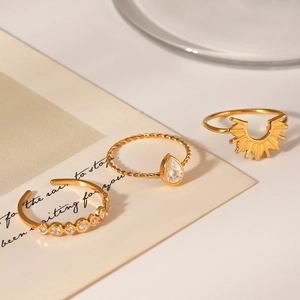 Three-piece stackable 18k gold plated ring set with sunburst design and zircon stones