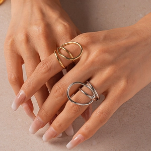 Close-up of minimalist layered double-ring geometric design on hand in gold and silver