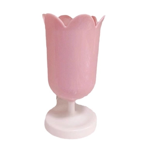 Pink tulip flower makeup brush holder with a round white base for stylish desk storage