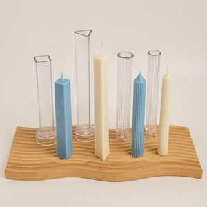 DIY candle making kit with geometric acrylic molds and textured column candles on tray