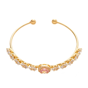 Elegant gold-plated open bangle with oval pink centerpiece and zircon accents