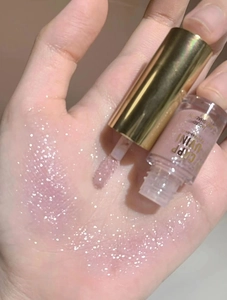 Macro shot of shimmering pink-purple liquid eyeshadow swatch with fine glitter finish