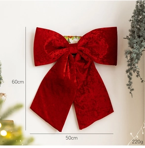 Detail view of a 60cm large red velvet Christmas bow with size dimensions and measurements