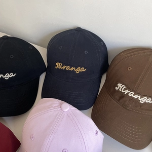 Detail shot of multi-color cotton baseball caps featuring elegant Hiranga embroidery