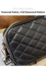 Detail of black quilted leather texture with gold zipper and woven pattern strap